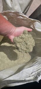 Hand holding milled lucerne